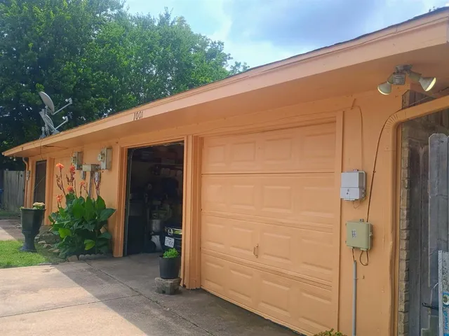 a front view of a house with a yard and green space