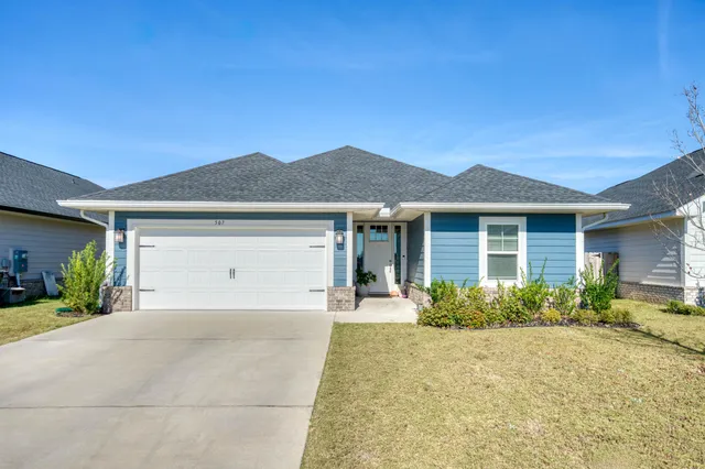 a front view of a house with garden