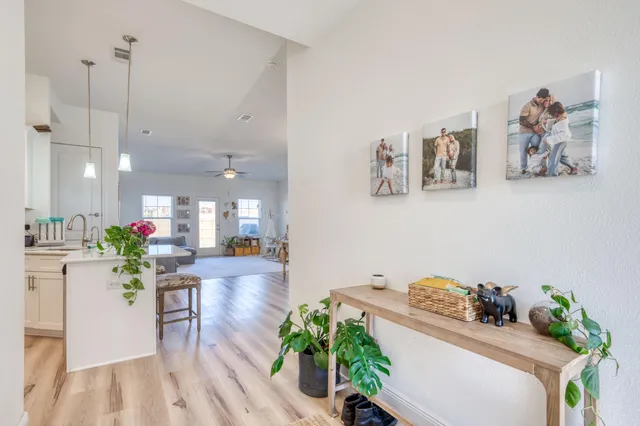 a spacious bathroom with a double vanity sink a toilet a shower and a large mirror