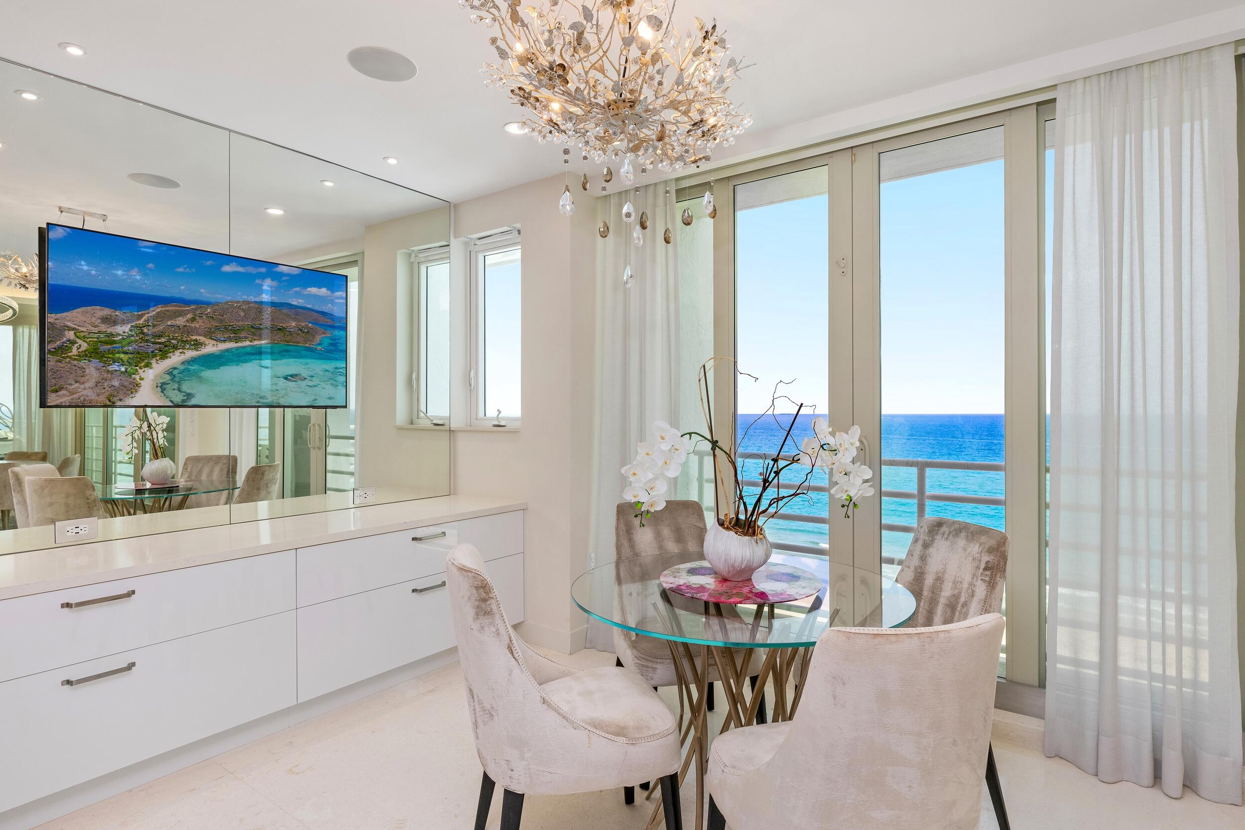 800 South Ocean Boulevard, Unit PH6 Boca Raton, FL 33432 - Photo 17 of 69 a view of a dining room with furniture large windows and wooden floor