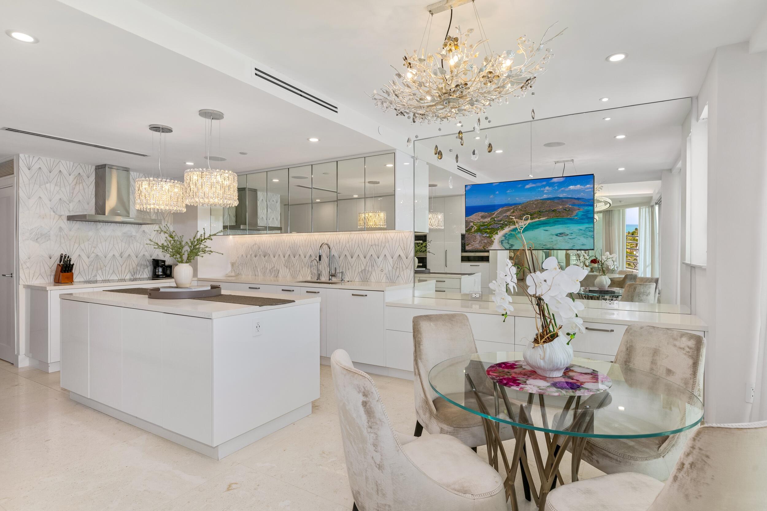 800 South Ocean Boulevard, Unit PH6 Boca Raton, FL 33432 - Photo 18 of 69 a kitchen with stainless steel appliances kitchen island granite countertop a dining table chairs sink and white cabinets