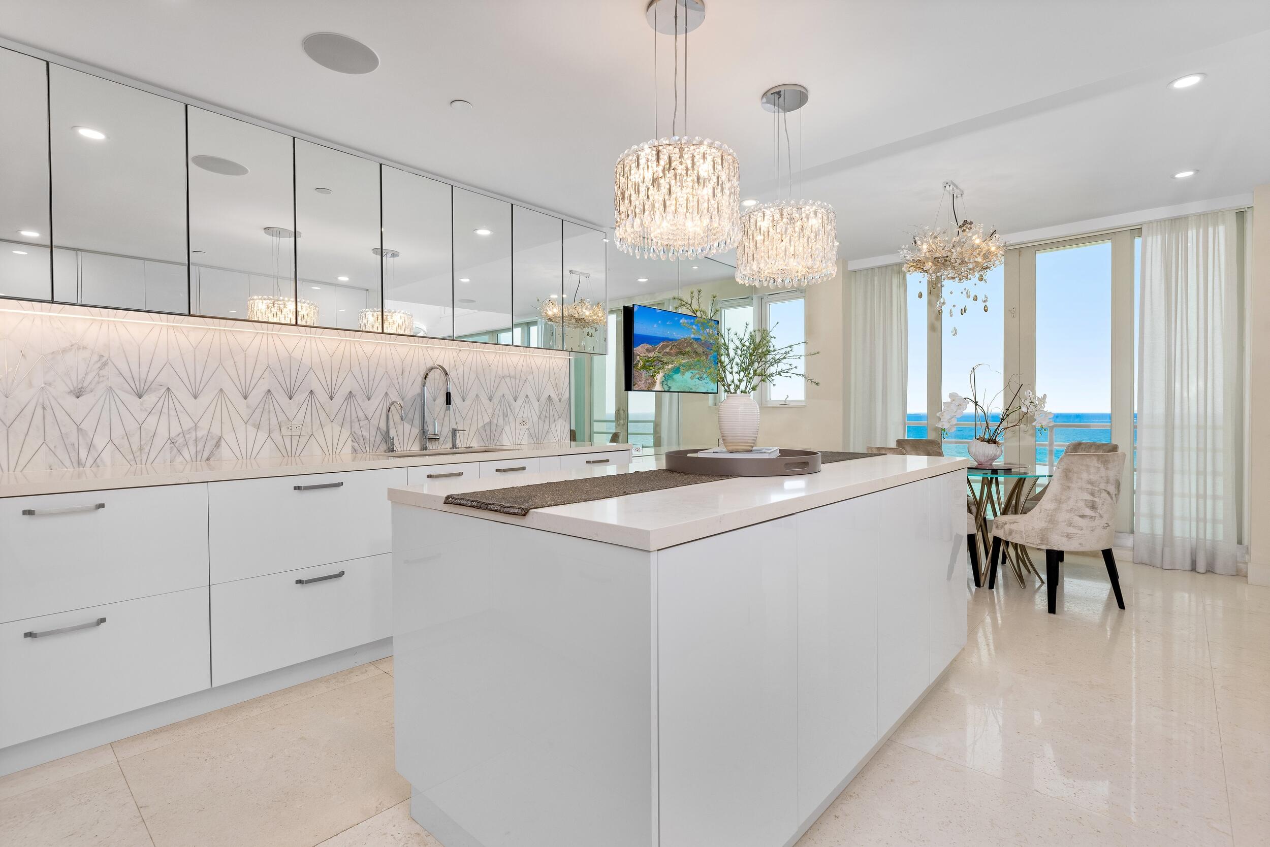 800 South Ocean Boulevard, Unit PH6 Boca Raton, FL 33432 - Photo 21 of 69 a kitchen with cabinets a sink and appliances