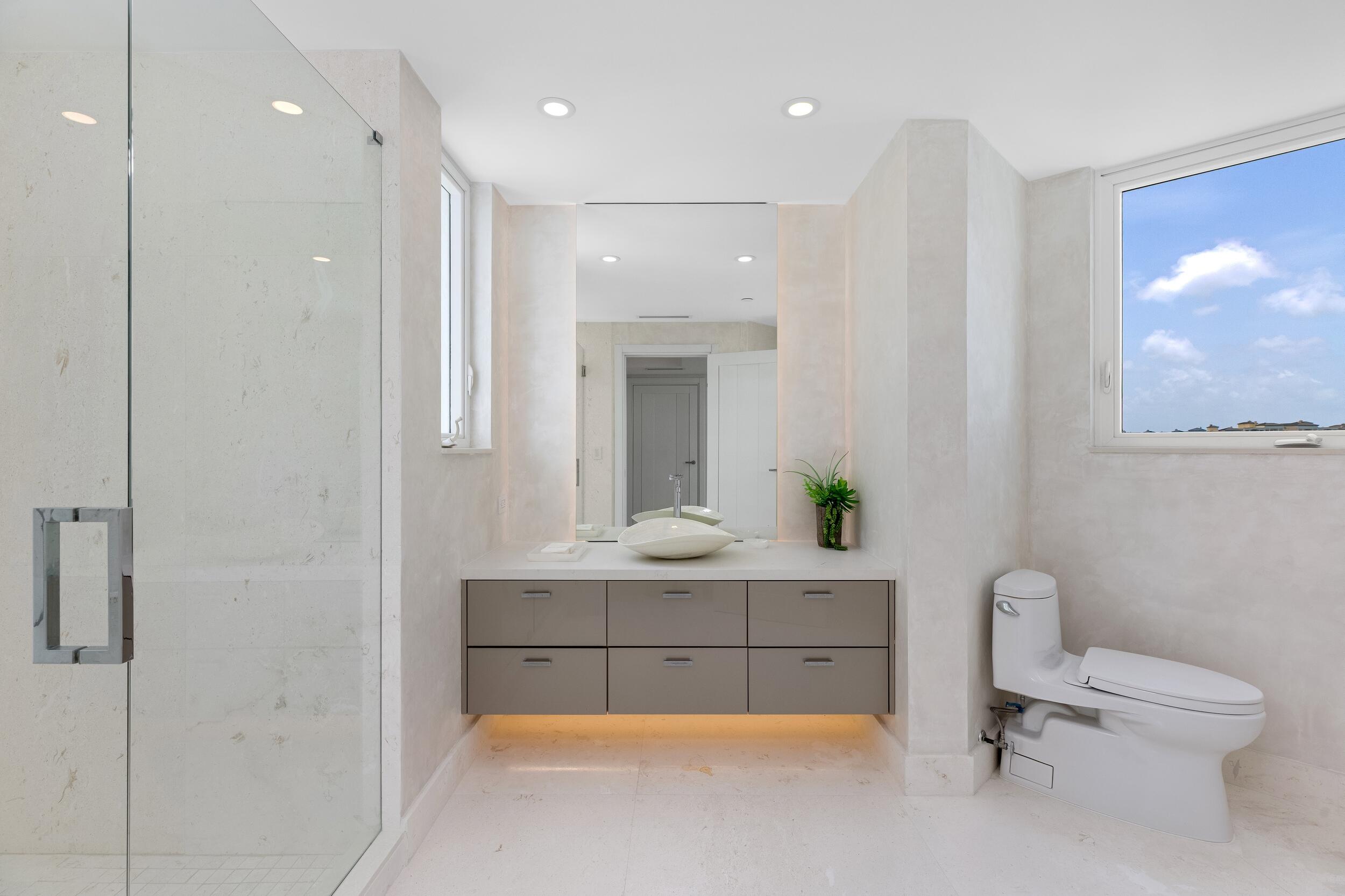 800 South Ocean Boulevard, Unit PH6 Boca Raton, FL 33432 - Photo 47 of 69 a bathroom with a tub sink toilet and mirror