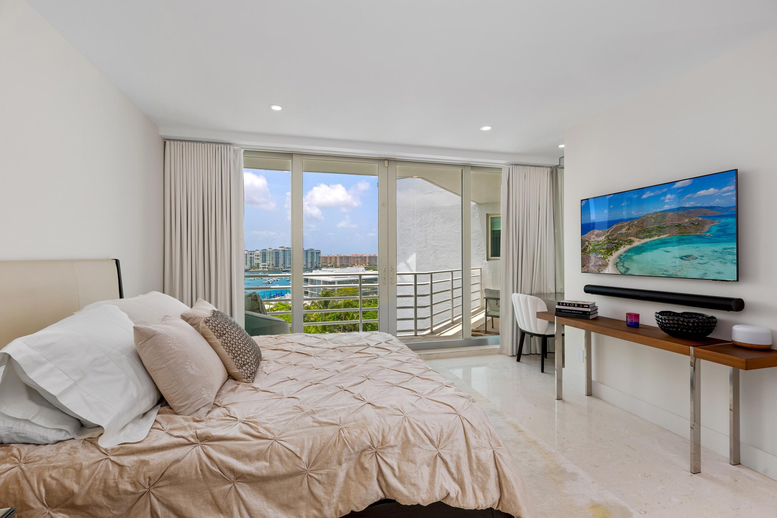 800 South Ocean Boulevard, Unit PH6 Boca Raton, FL 33432 - Photo 50 of 69 a bedroom with a bed and a flat screen tv