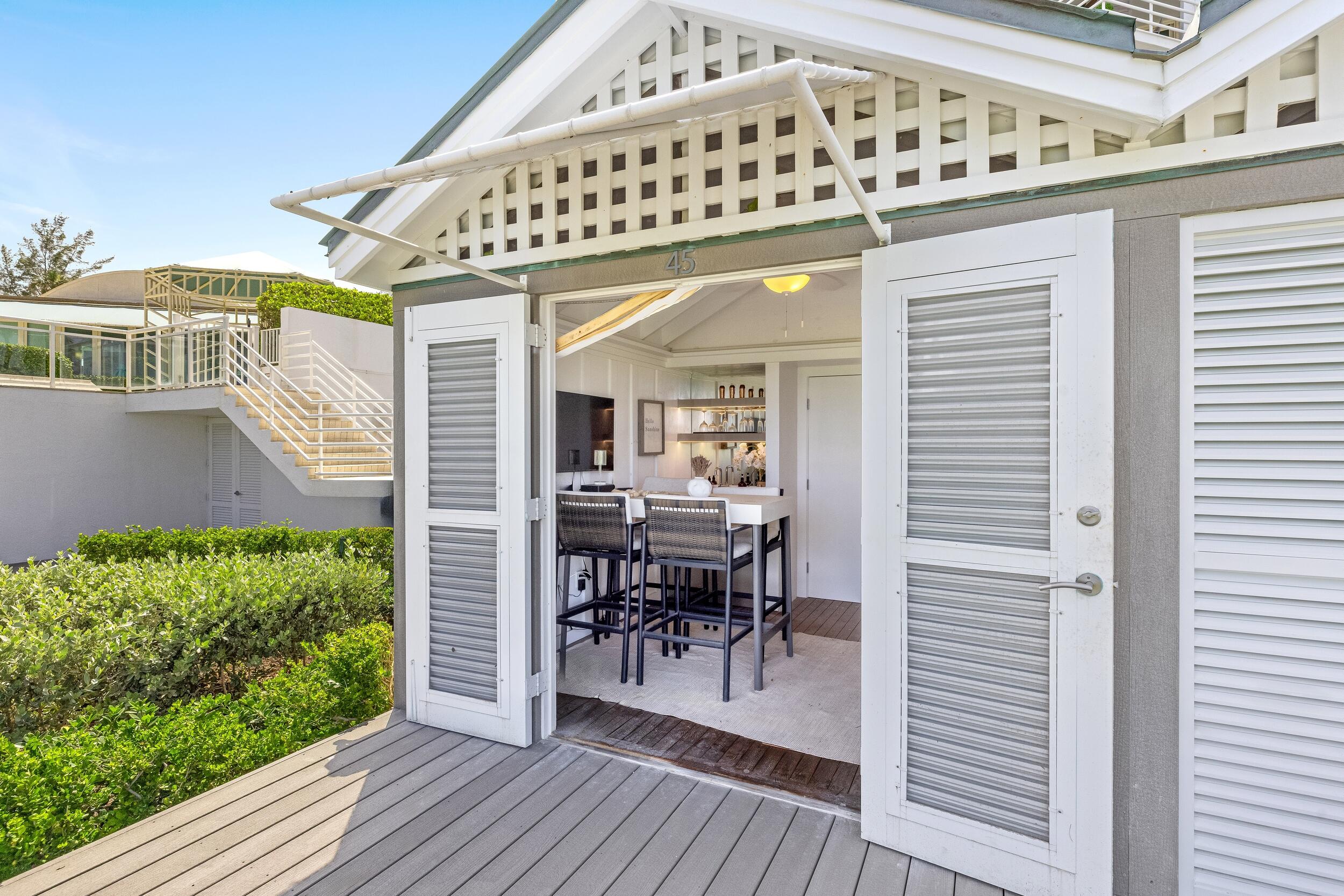 800 South Ocean Boulevard, Unit PH6 Boca Raton, FL 33432 - Photo 60 of 69 a view of a patio with table and chairs with wooden floor and fence