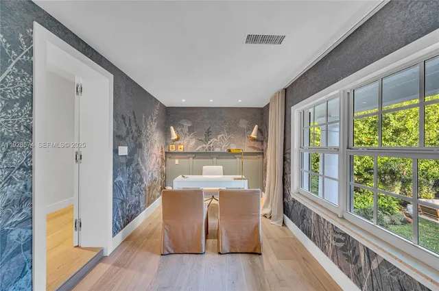 a living room with furniture and kitchen view