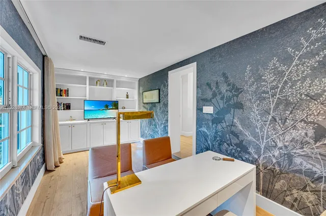 a bedroom with furniture and a large window