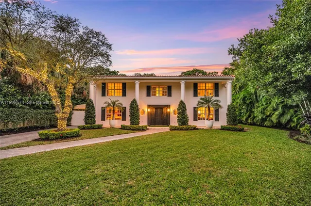 a front view of house with yard and green space