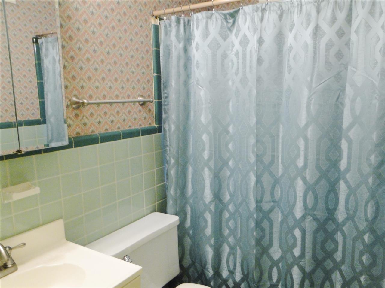 5000 Sea Isle Road Memphis, TN 38117 - Photo 9 of 14 a bathroom with a sink a toilet and a shower curtain