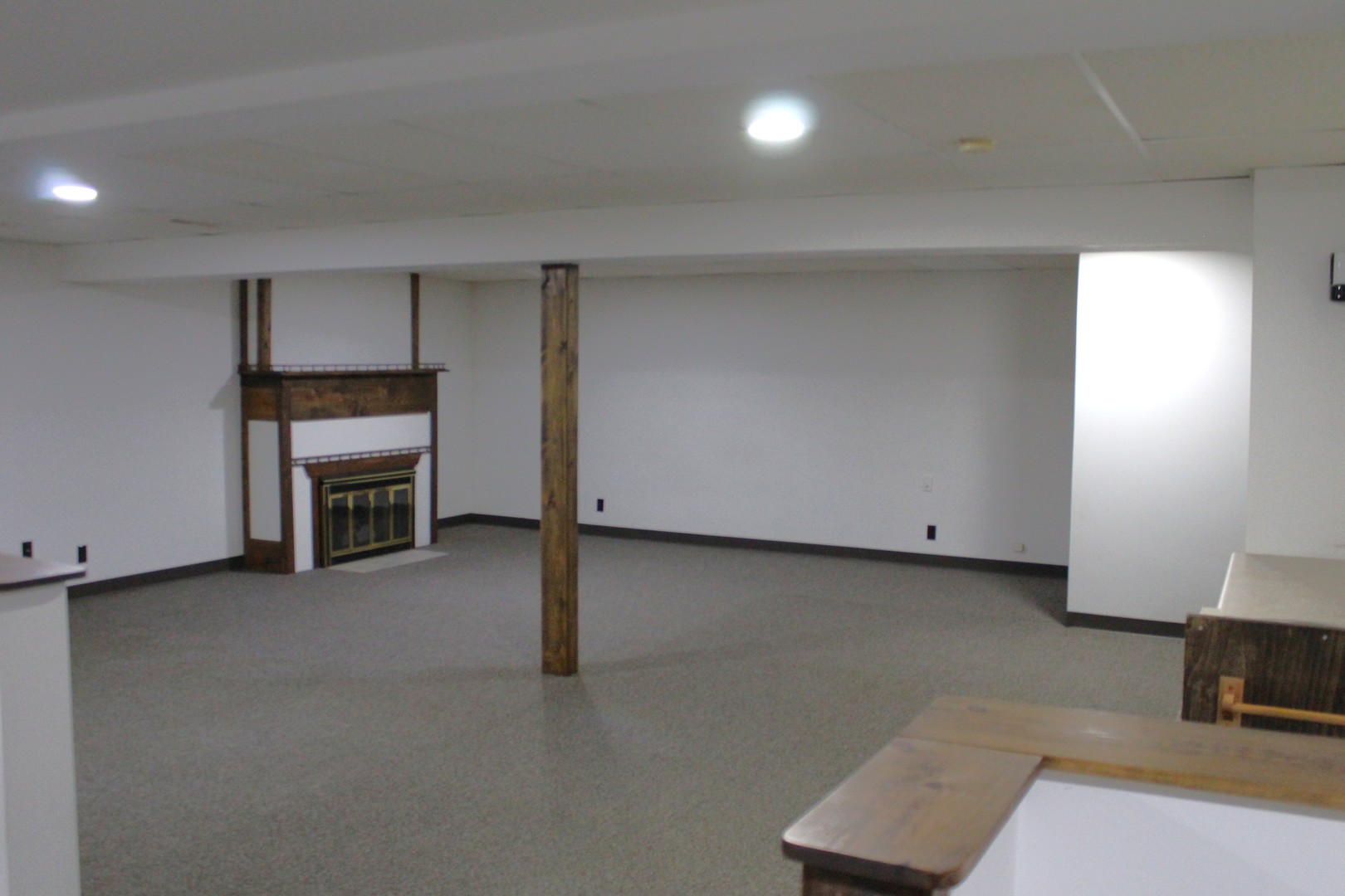 908 Glenmore Lane Elgin, IL 60124 - Photo 27 of 50 an empty room with a fireplace and mirrors