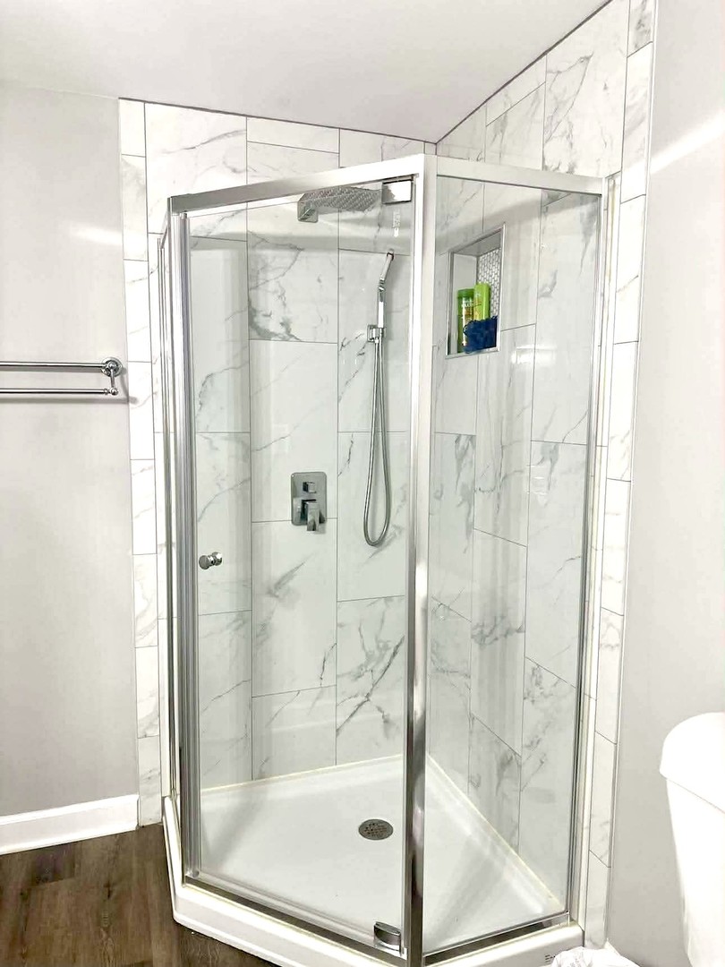 908 Glenmore Lane Elgin, IL 60124 - Photo 33 of 50 a bathroom with a glass shower door