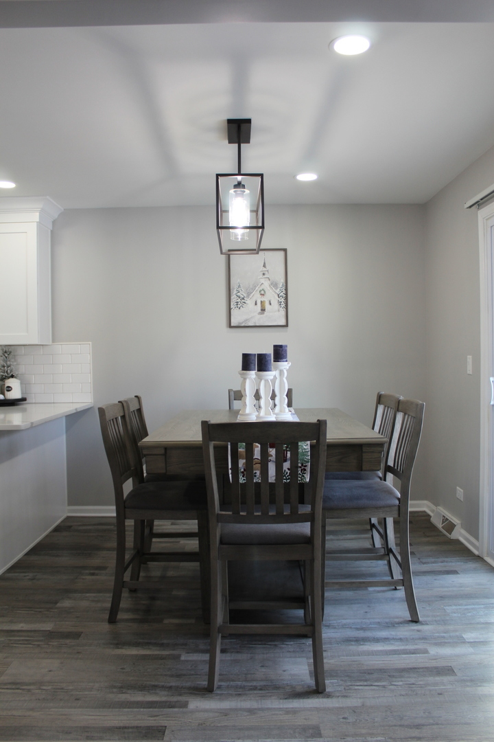 908 Glenmore Lane Elgin, IL 60124 - Photo 8 of 50 a view of a dining room with furniture and wooden floor