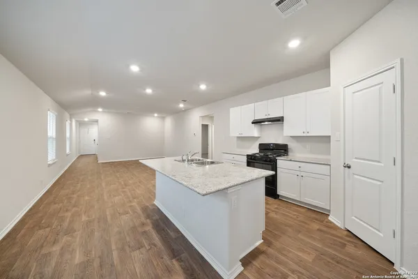 a kitchen with a sink stove and refrigerator
