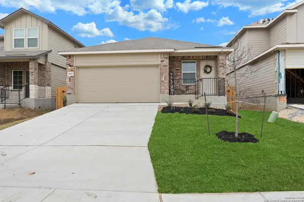 a view of a house with a backyard