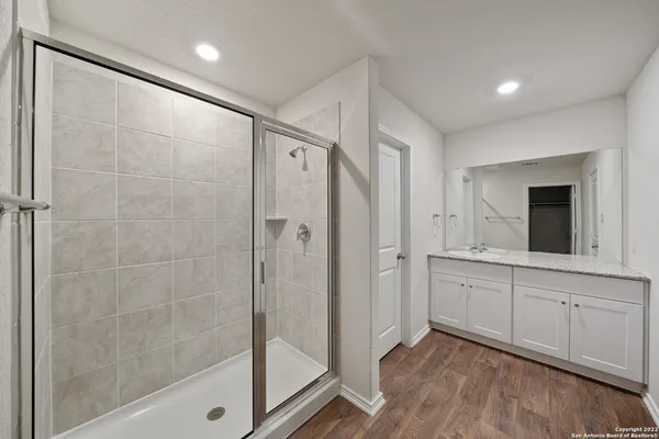 a bathroom with a shower and a sink