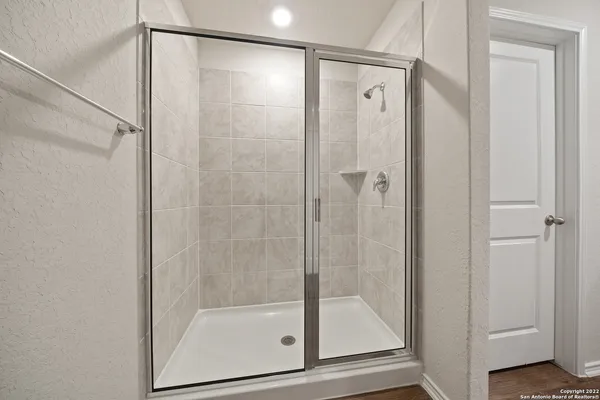 a bathroom with a glass shower door