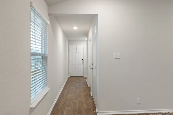 a view of a room with wooden floor and windows