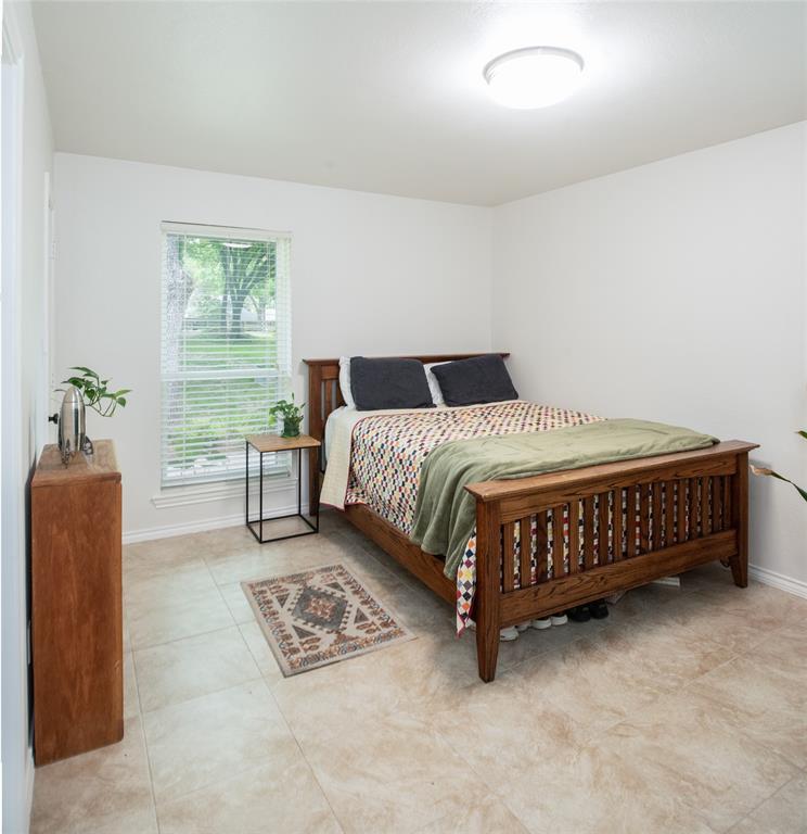 1451 Meandro Ria Lane Fairview, TX 75069 - Photo 31 of 38 a bedroom with a bed window and a couch