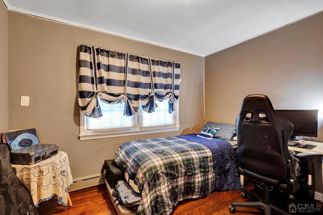 23 Valley Road Colonia, NJ 07067 - Photo 18 of 32 a bedroom with a bed and wooden floor