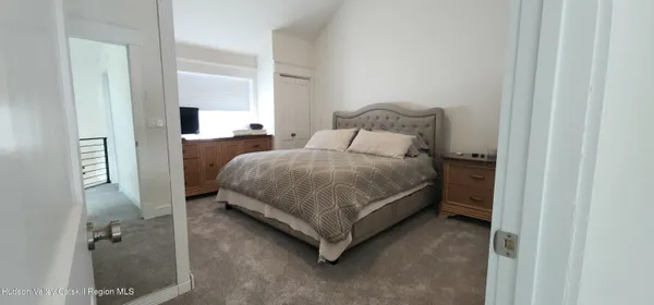 a bedroom with a bed and a mirror
