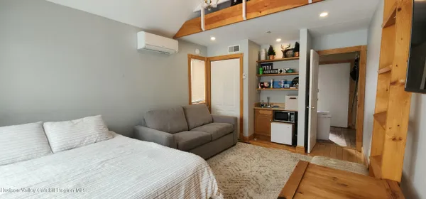 a bedroom with furniture and a rug