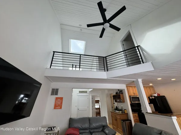 a living room with furniture and a ceiling fan