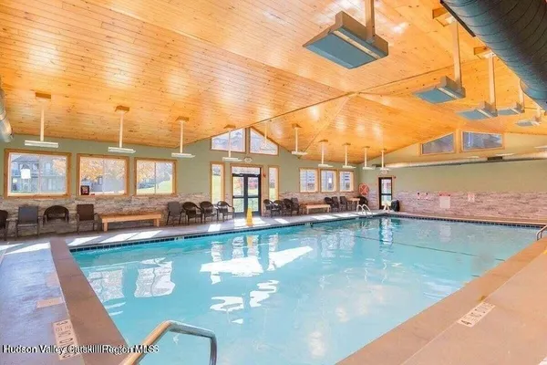 a view of a swimming pool with outdoor seating