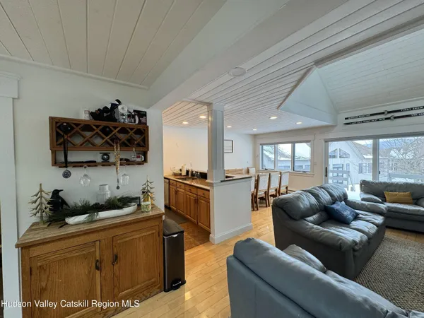 a living room with furniture a flat screen tv and a large window