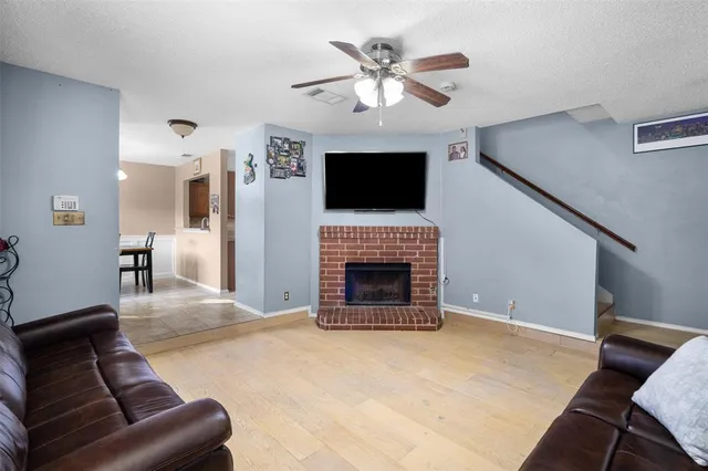 a living room with furniture a fireplace and a flat screen tv