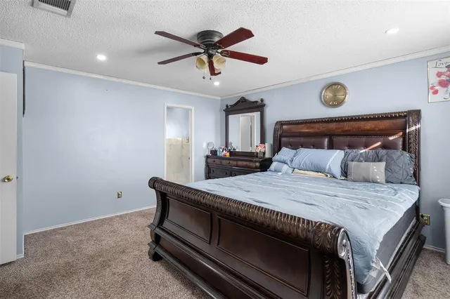 a bedroom with a bed and a ceiling fan