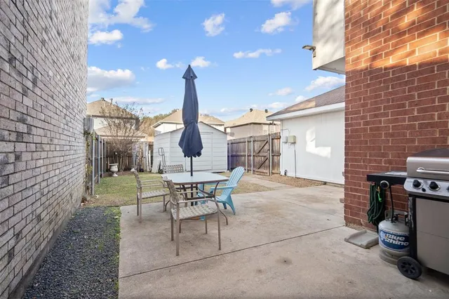 a view of a patio with a table and chairs
