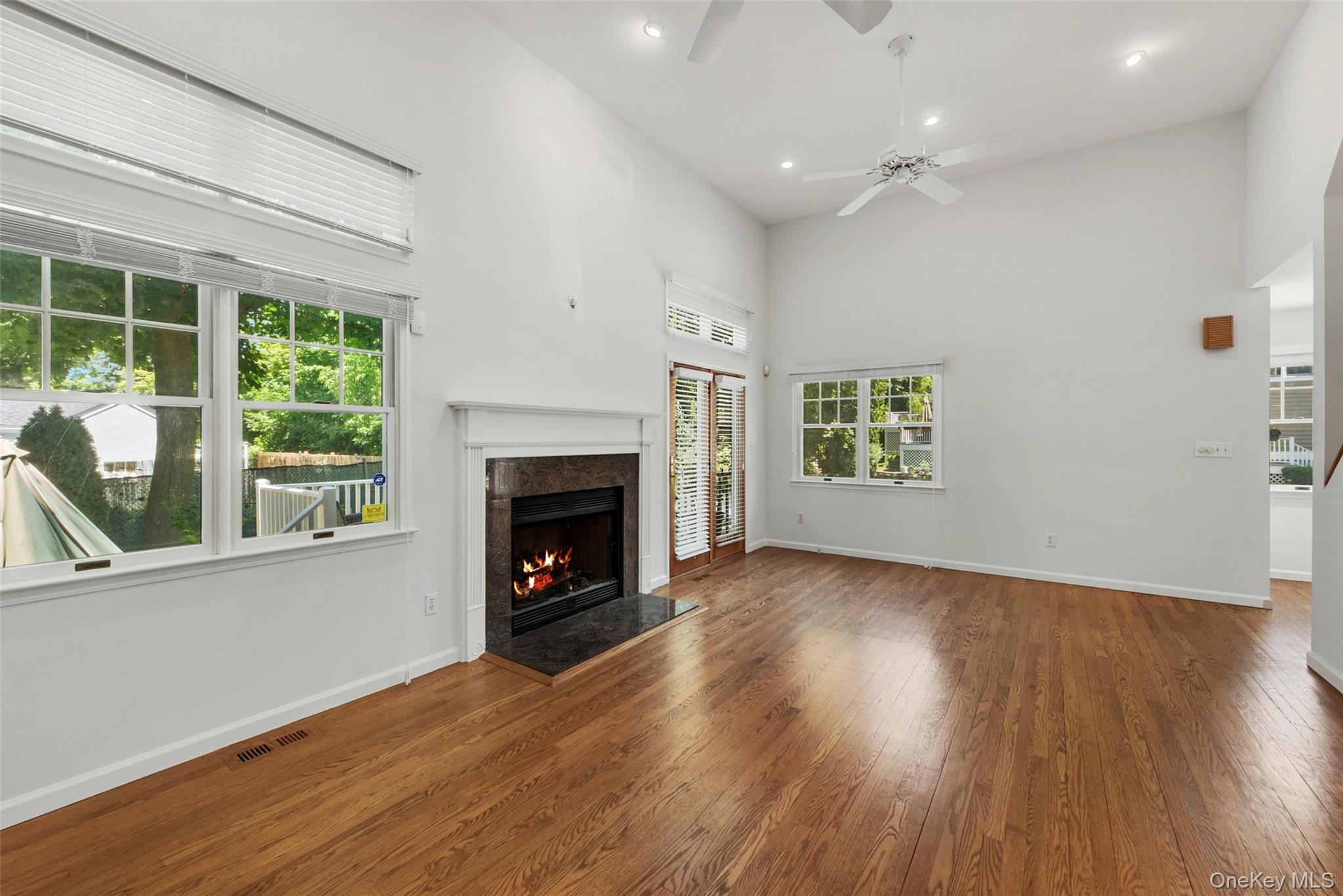 21 Brookridge Court Rye Brook, NY 10573 - Photo 4 of 20 Large living room with sliding glass door to private deck and gas fireplace.