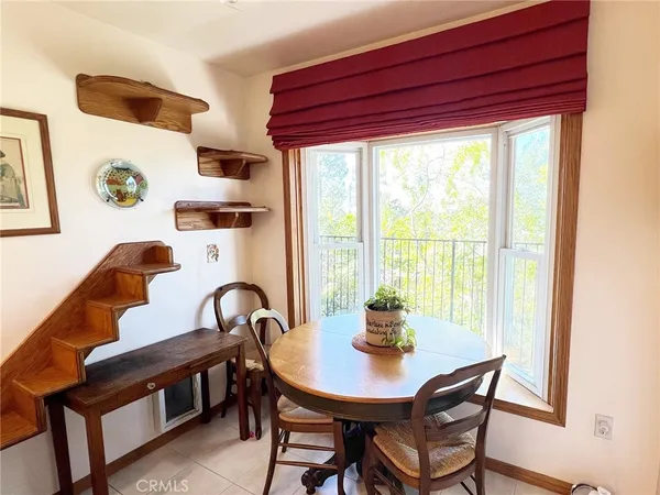 a view of a dining room with furniture and window
