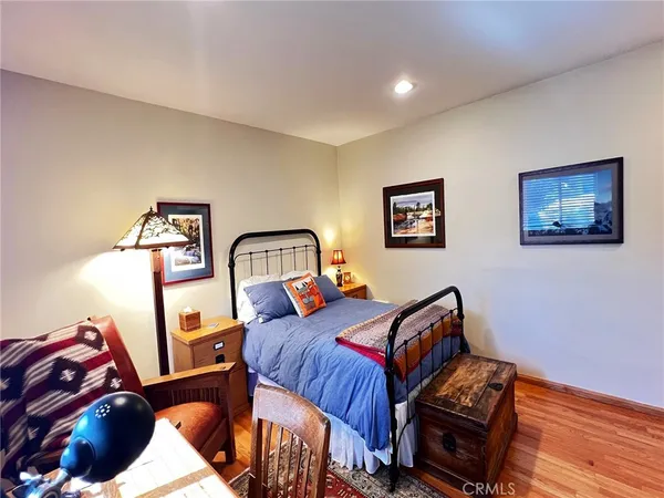 a bedroom with furniture and wooden floor
