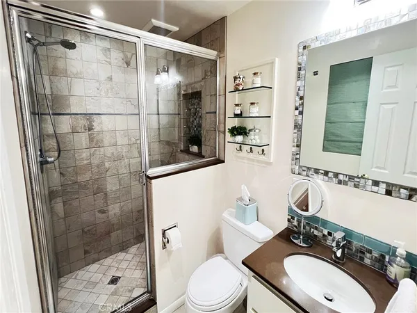 a bathroom with a sink a toilet and shower