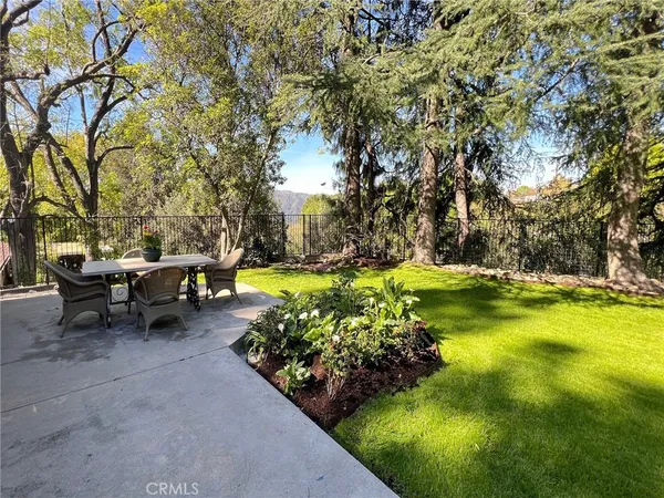 a view of swimming pool with sitting area and garden