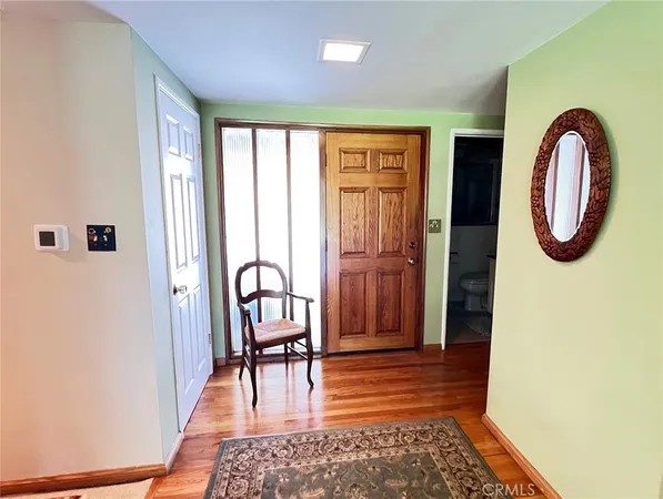 a view of a hallway with furniture and entryway