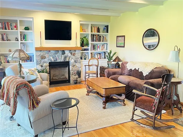 a living room with furniture fireplace and a flat screen tv