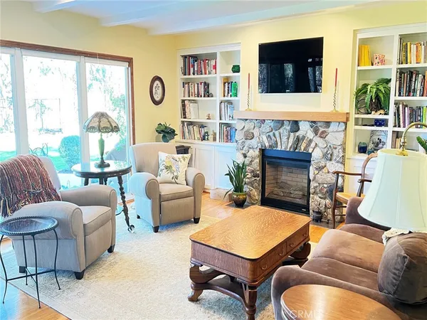 a living room with furniture fireplace and window