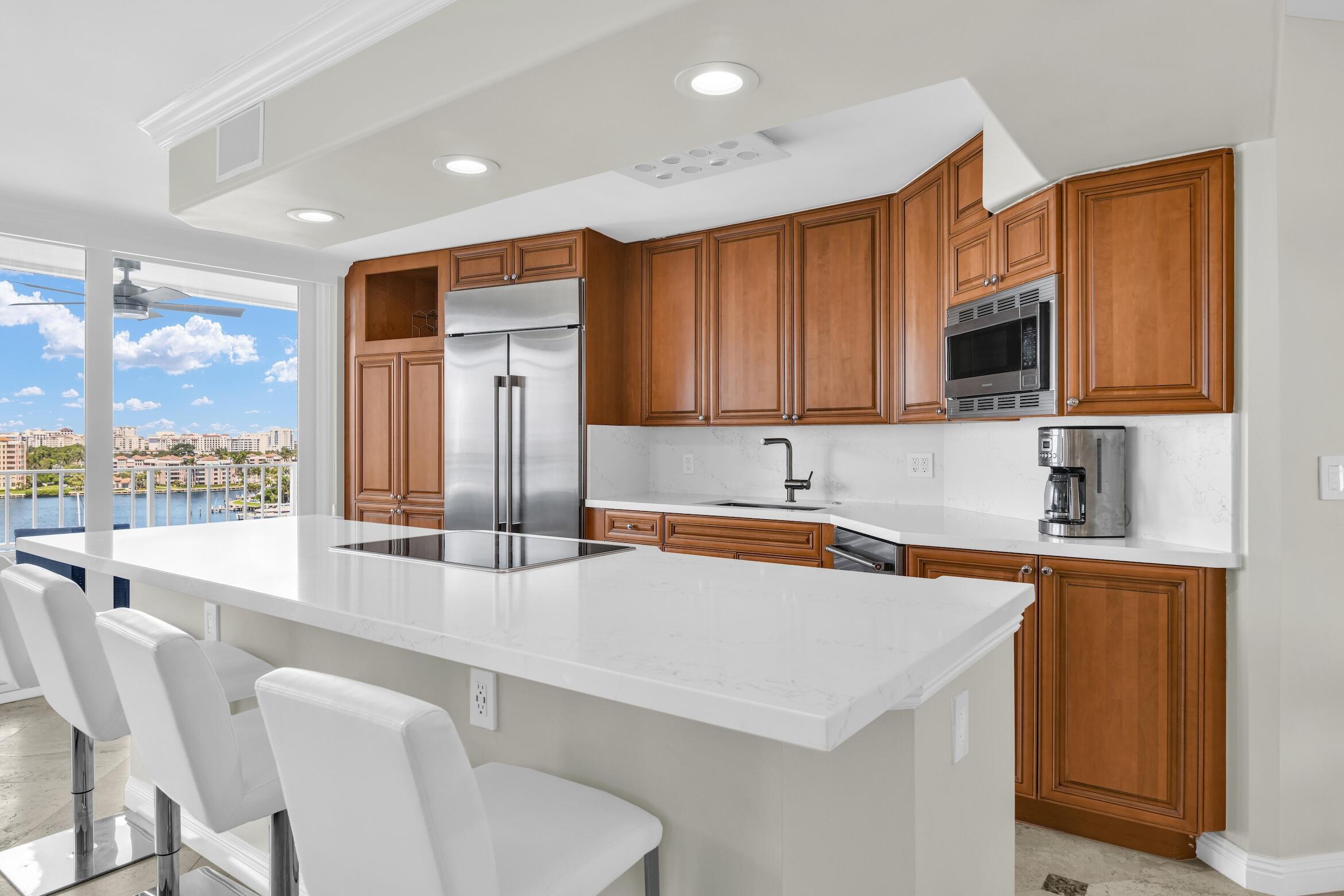 500 South Ocean Boulevard, Unit 1009 Boca Raton, FL 33432 - Photo 7 of 57 a kitchen with stainless steel appliances a sink a stove a refrigerator cabinets and a counter top space