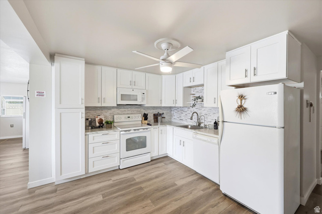215 Carol Way Midvale, UT 84047 - Photo 11 of 30 Kitchen featuring white appliances, ceiling fan, white cabinetry, light wood-type flooring, and decorative backsplash