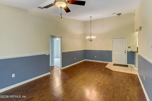 a view of a livingroom with a ceiling fan and wooden floor