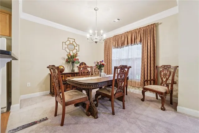 a view of a dining room with furniture and window