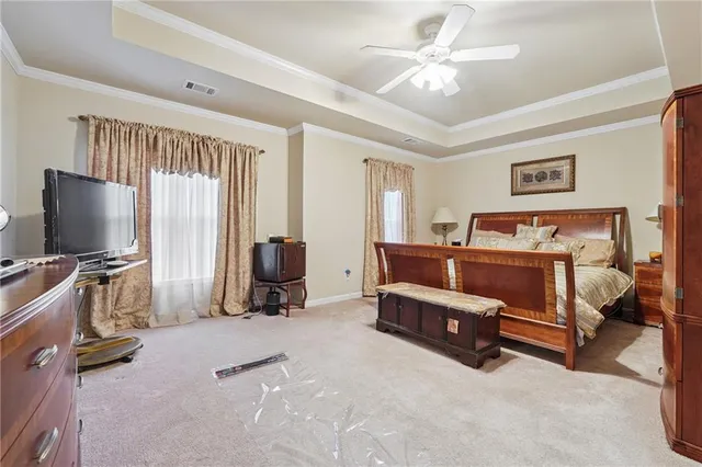 a bedroom with furniture and a flat screen tv