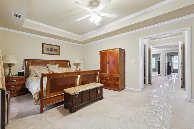 a bedroom with a bed and a chandelier