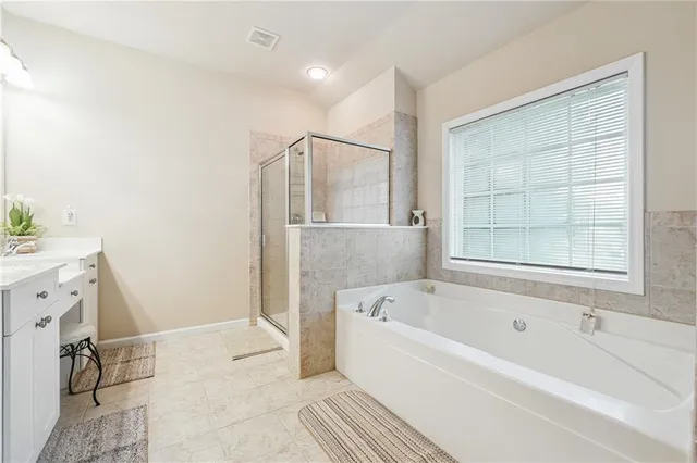 a bathroom with a bathtub and a shower