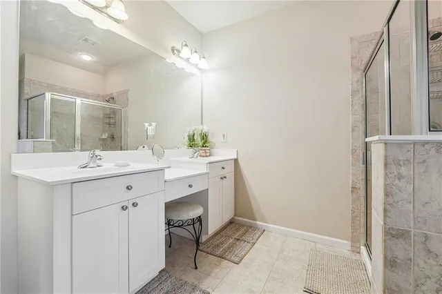 a bathroom with a sink double vanity and a mirror