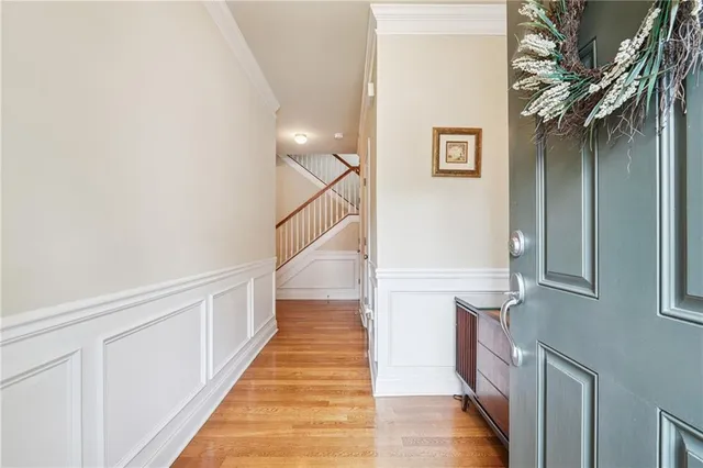 a view of a hallway with wooden floor and staircase