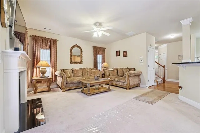 a living room with furniture and a chandelier