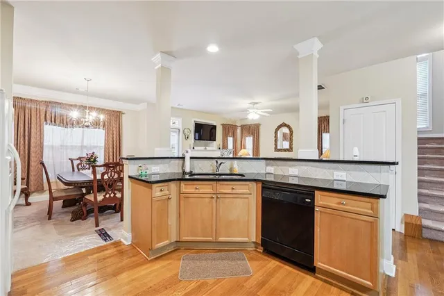 a kitchen with granite countertop a stove and white cabinets